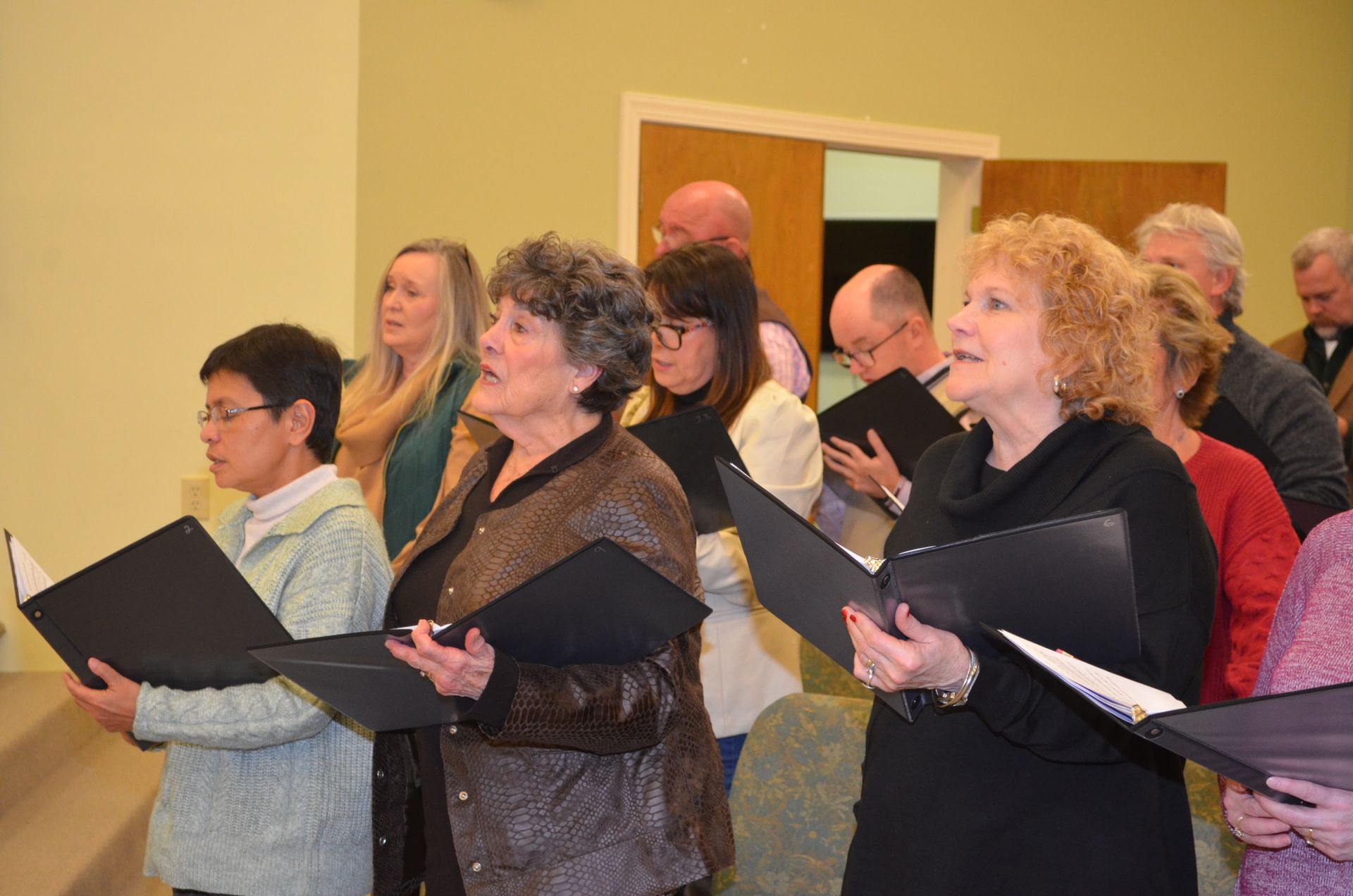 A group of people are singing together in a choir