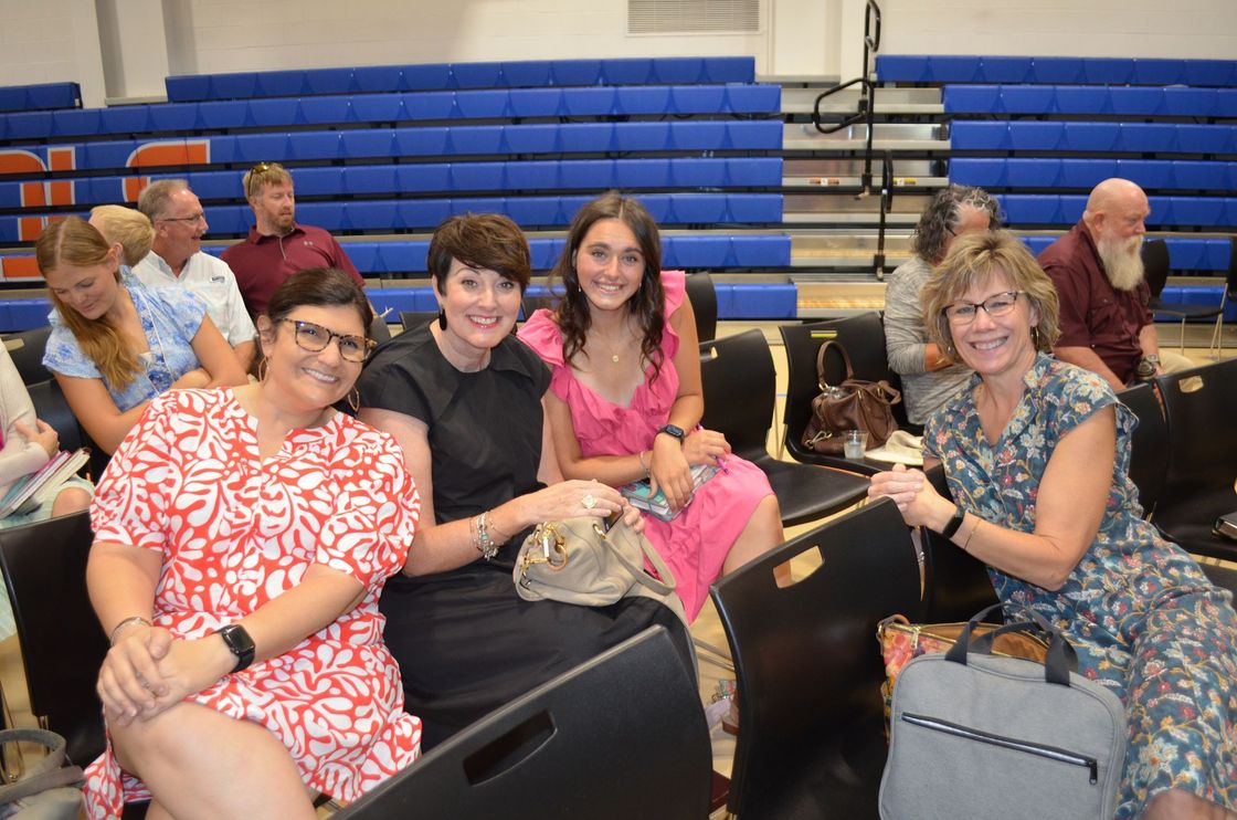 A group of women are sitting in a stadium.