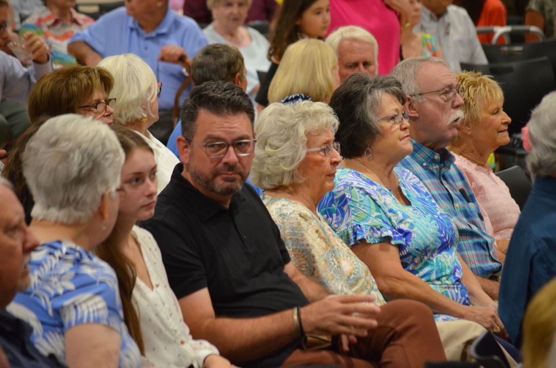 A large group of people are sitting in a room.