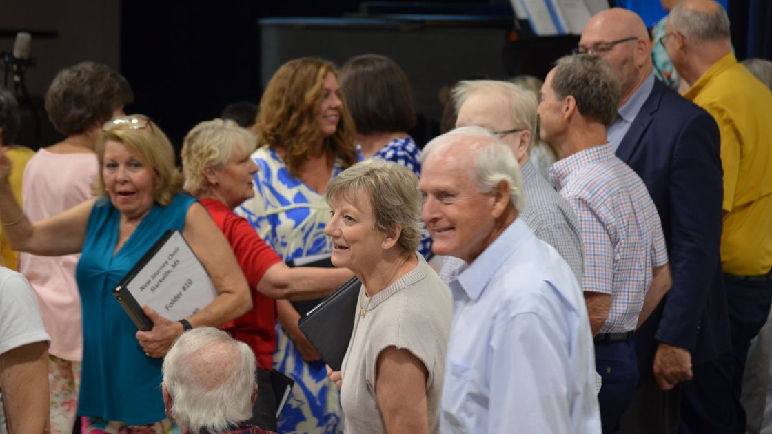 A group of people are standing in a line.