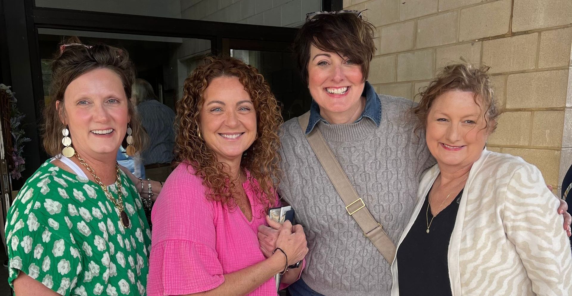 A group of women are posing for a picture together.