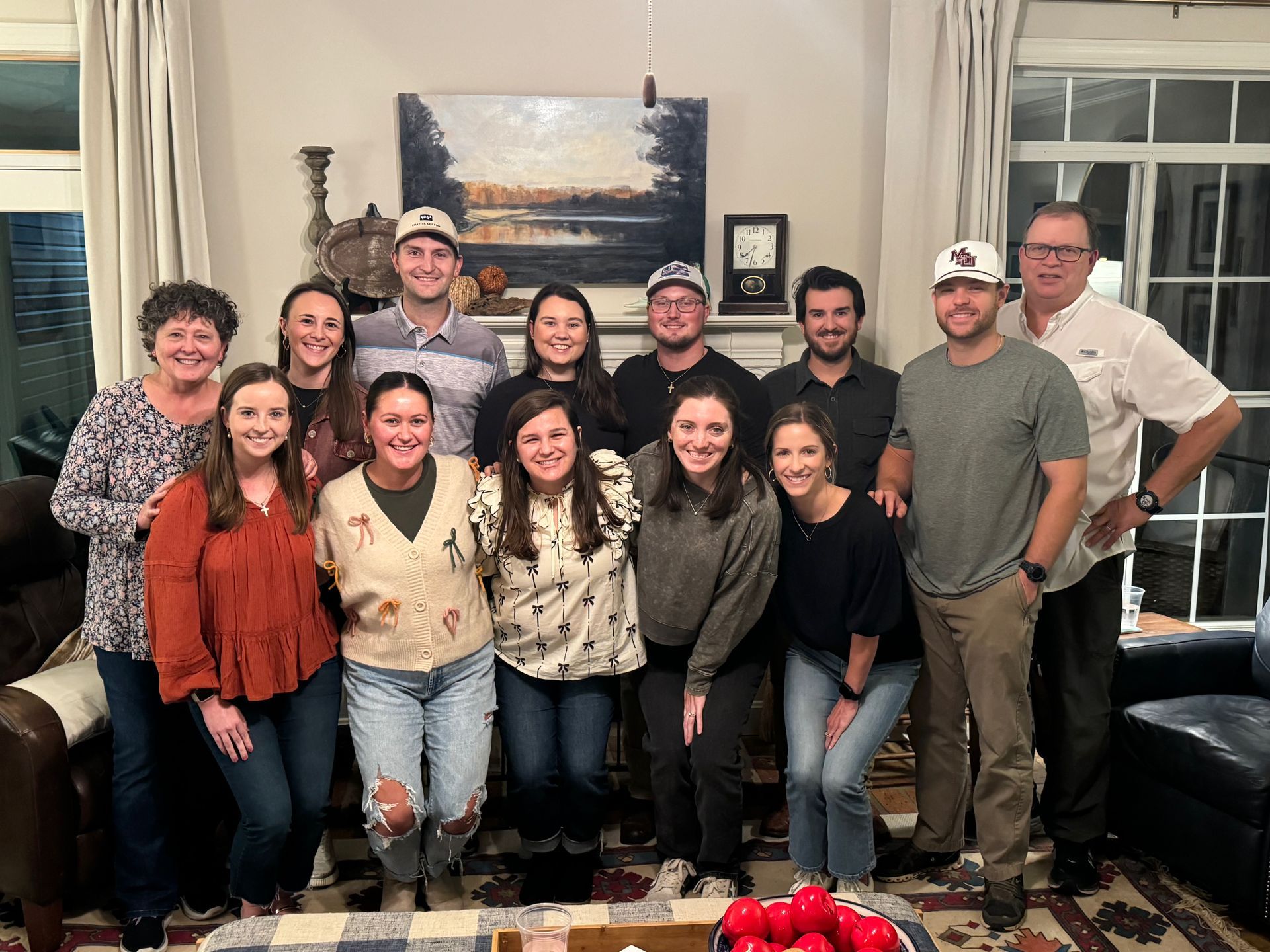 A group of people are posing for a picture in a living room.