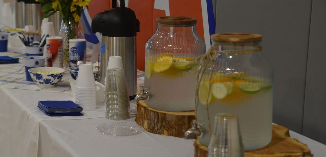 A table with a variety of drinks and glasses on it.