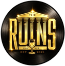 The Ruins Night Club logo in gold on a black vinyl record background