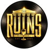The Ruins Night Club logo in gold on a black vinyl record background