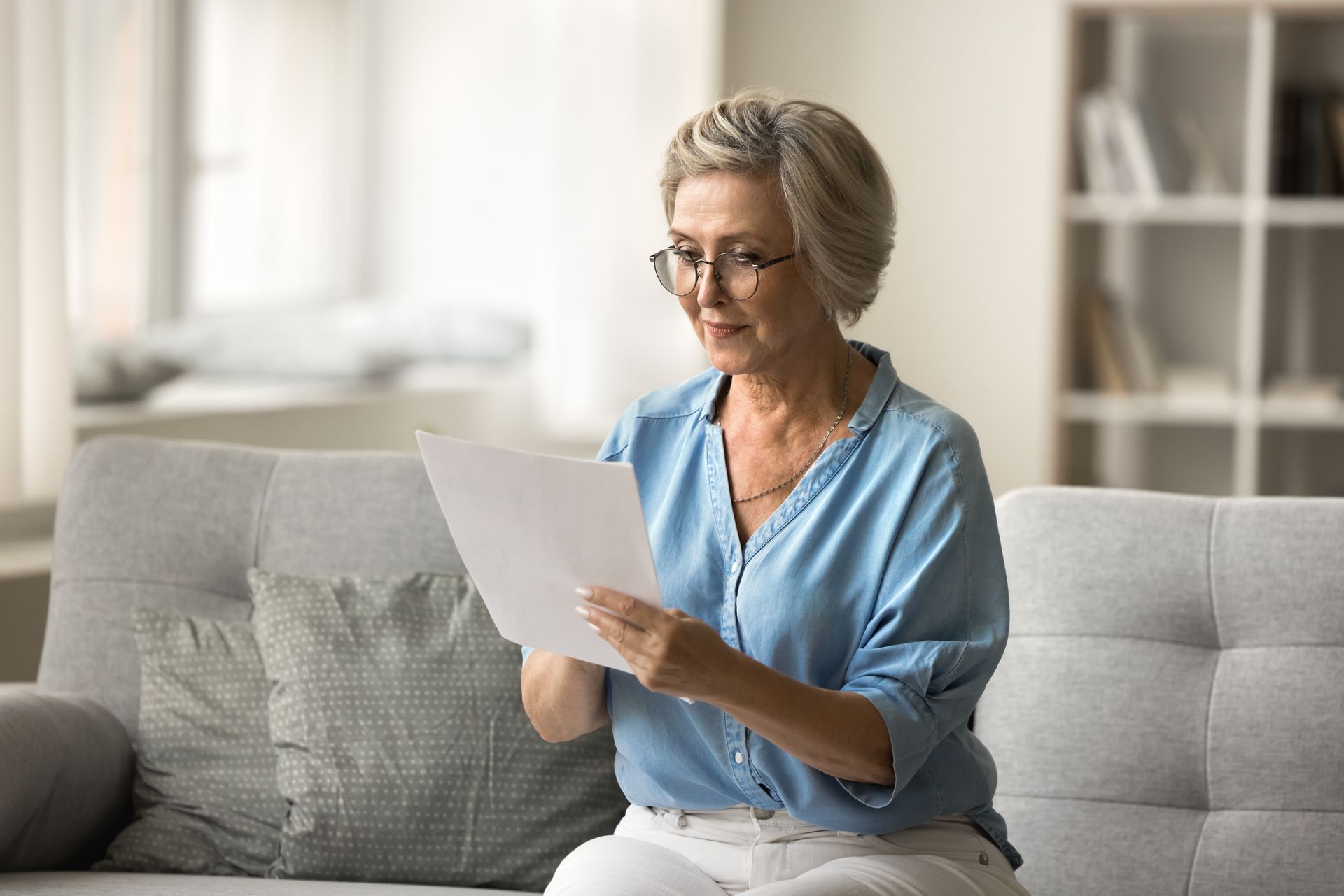 Elderly woman checking her insurance