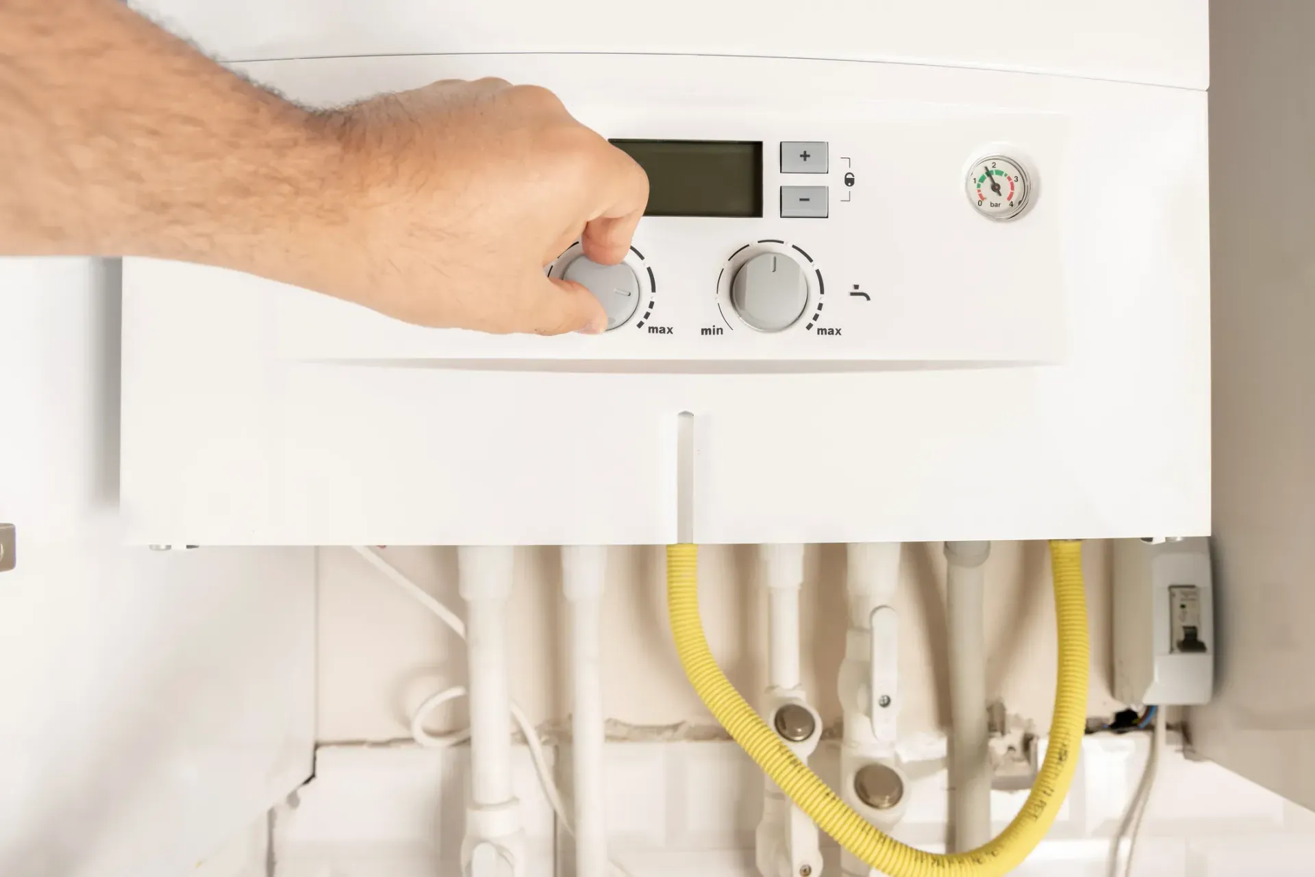 A person is adjusting the temperature on a boiler in Vancouver, WA