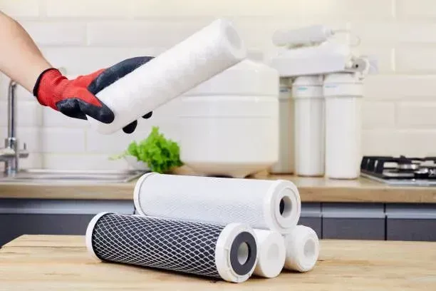 A person is holding a filter in their hand in a kitchen in Vancouver, WA