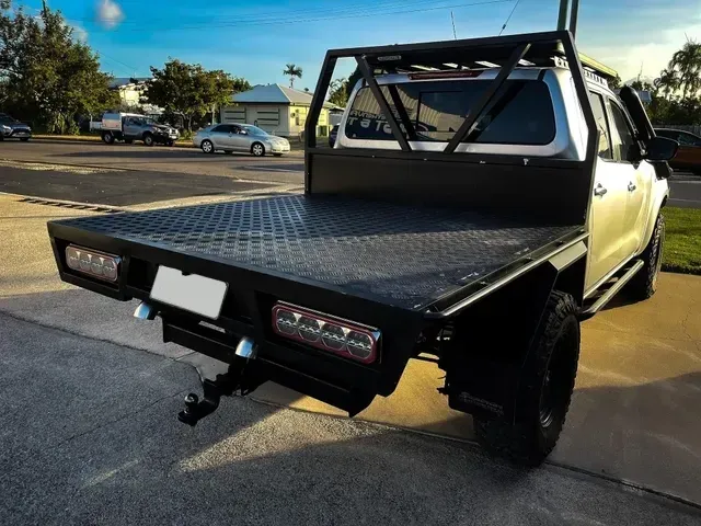 White Pickup Truck With a Black Flatbed and Roll Bar — Aitkenvale Exhausts & Towbars Pty Ltd In Aitkenvale, QLD