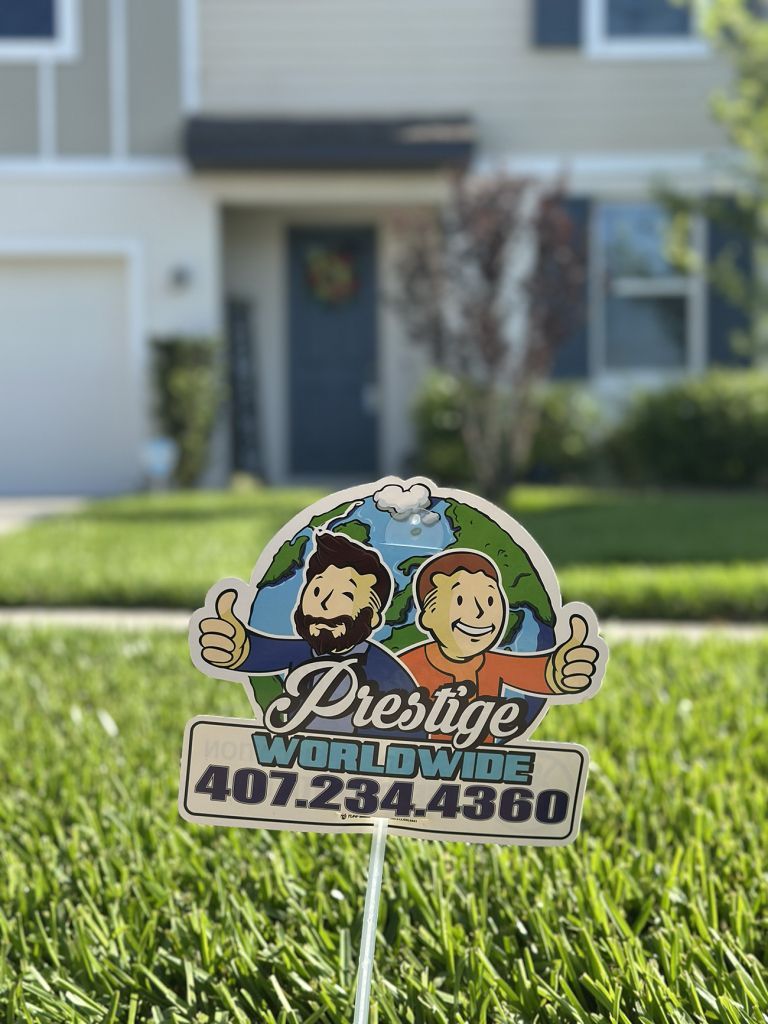 Prestige Weed Removal yard sign in green grass in front of a house
