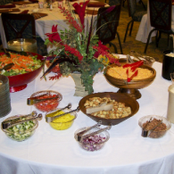 Buffet table with bowls of colorful salads and side dishes at a catered event