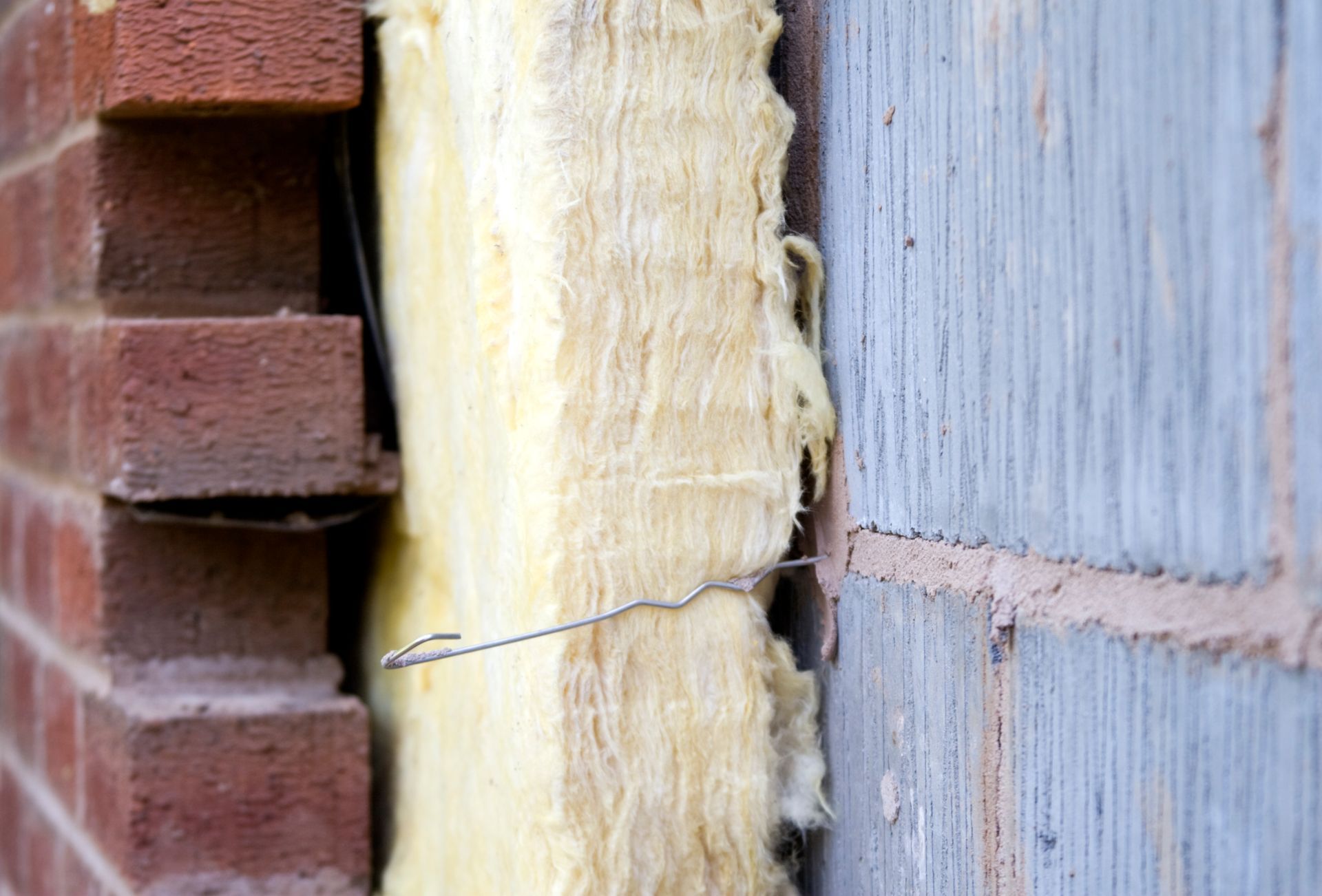 Soundproof home insulation between a brick and cement wall.