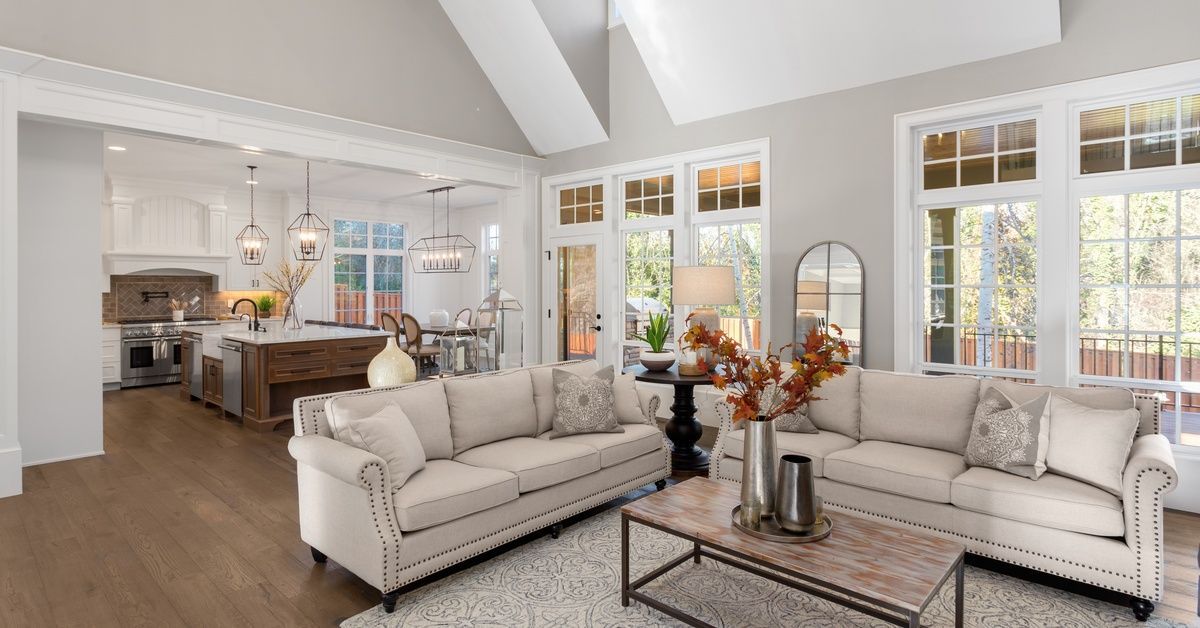 An open-concept living, dining, and kitchen space has ample natural light. The path around the kitch