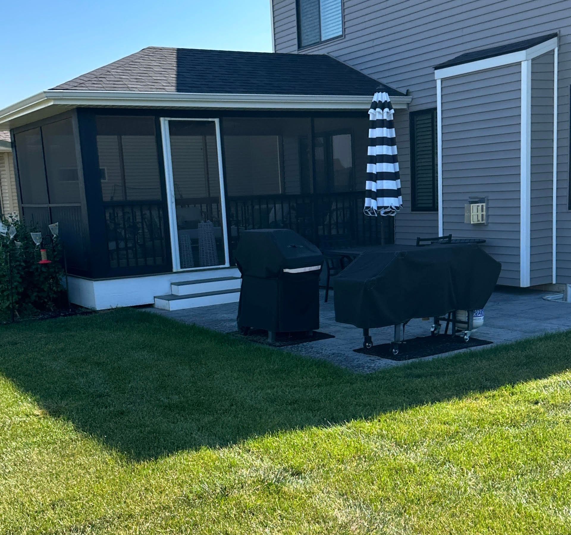 A wooden deck is being built in a backyard.