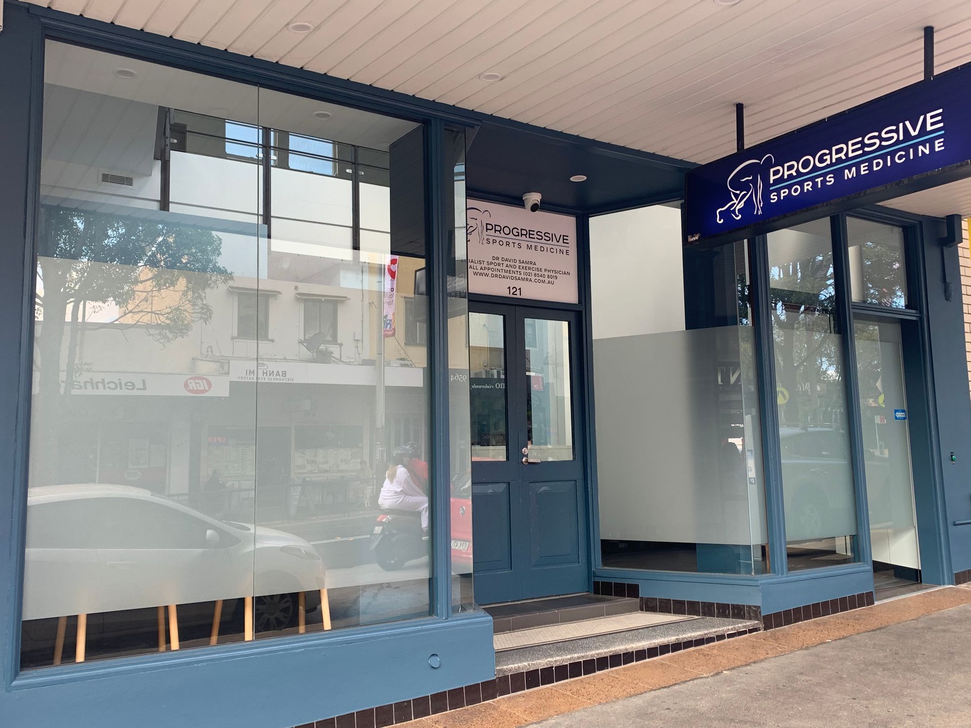 The front of Progressive Sports Medicine Leichhardt with a sign that says progressive sports medicine.