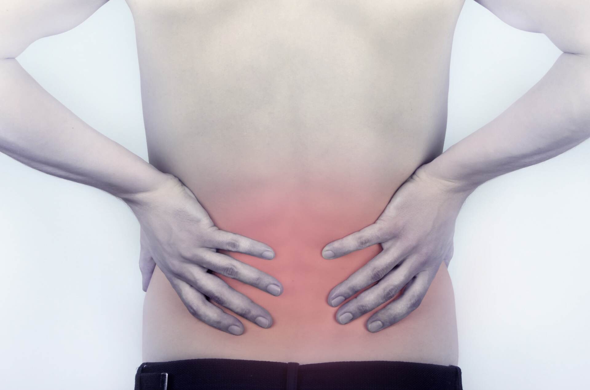 Person holding lower back with red pain area, suggesting back pain.