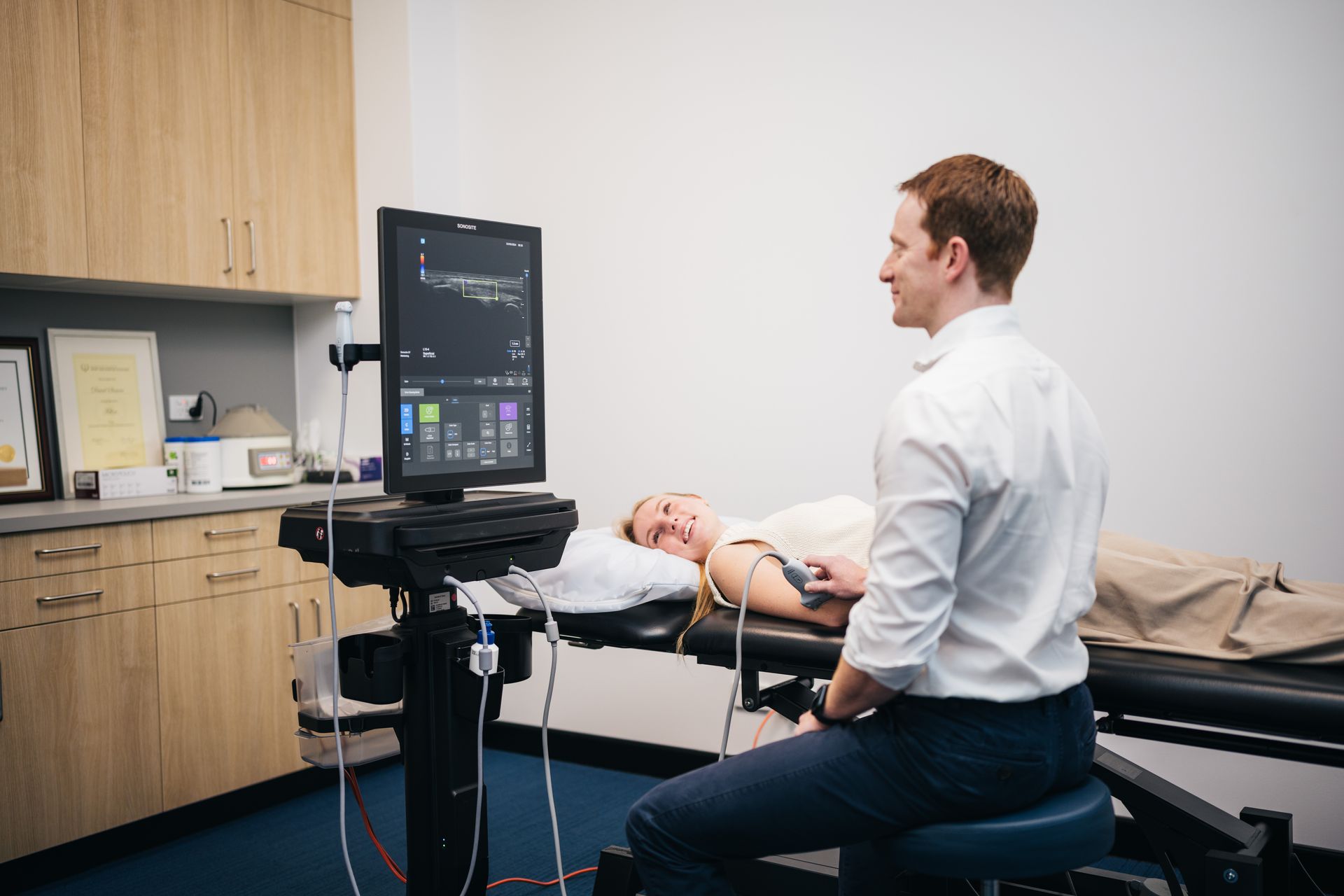 Dr David Samra performing a diagnostic ultrasound in a consulting room