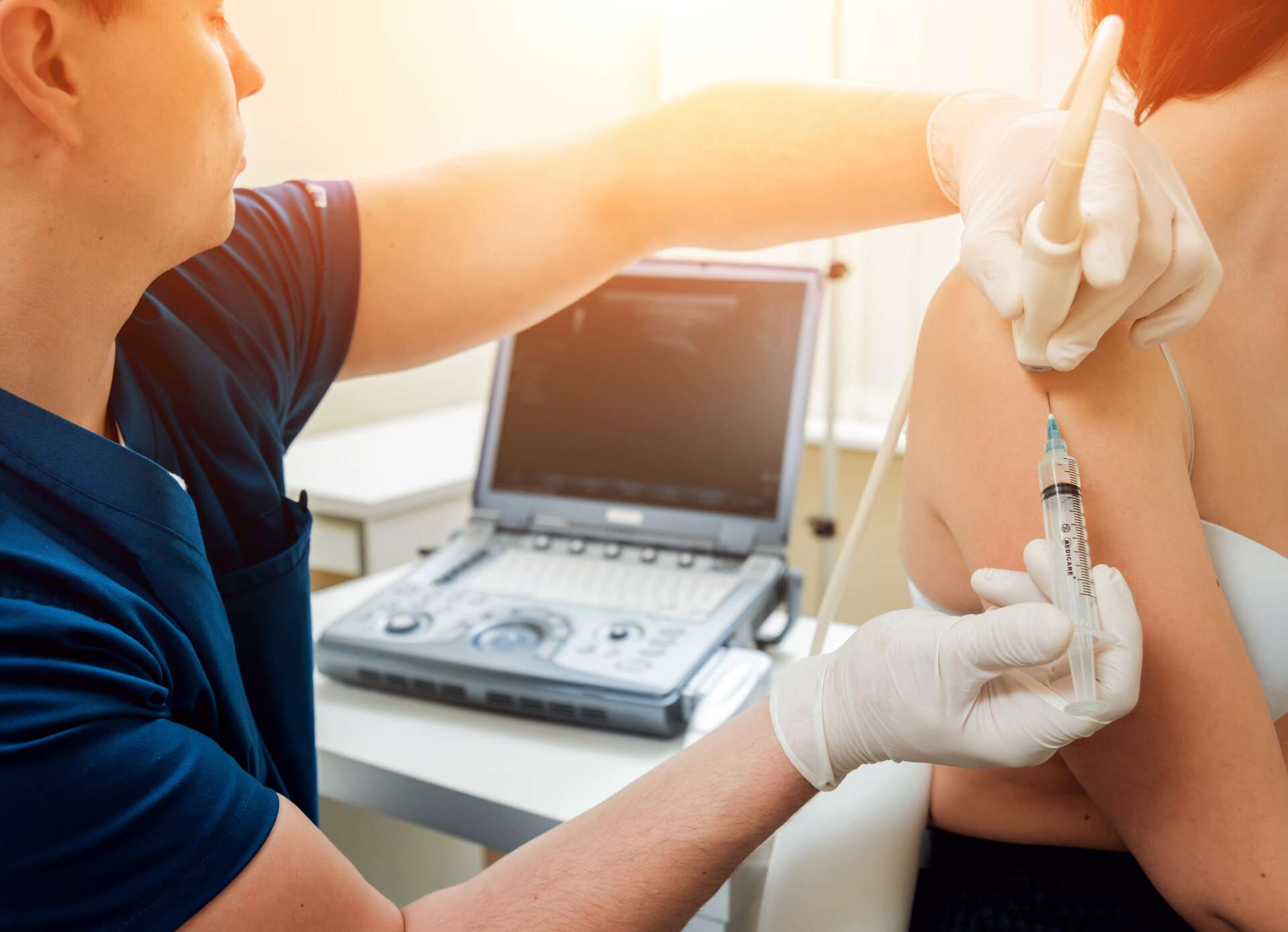 A doctor is giving a woman an injection in her arm.