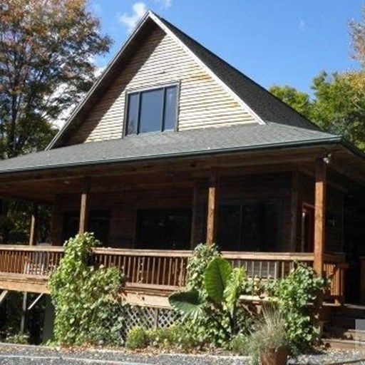 A house with a large porch and a large window
