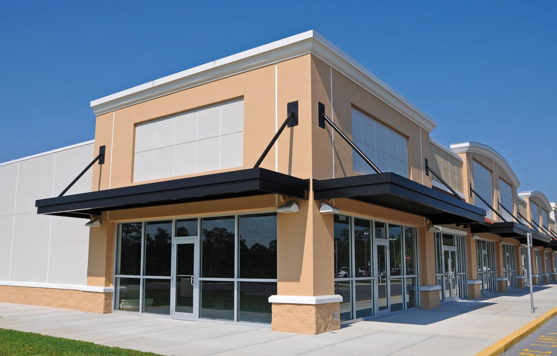 A large building with a lot of windows and a canopy.
