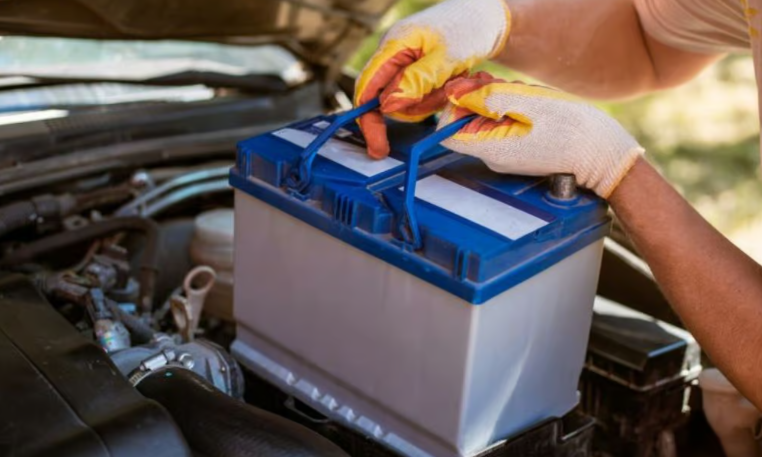 Car battery being removed and replaced by roadside technician