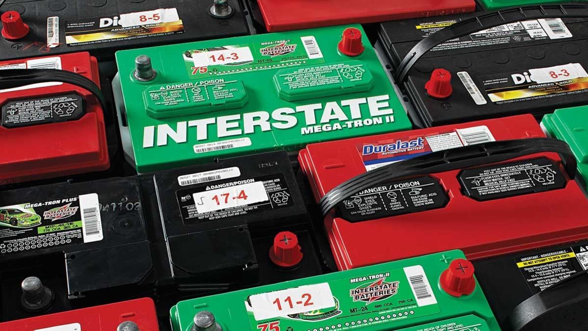 A bunch of car batteries side by side from different manufacturers.