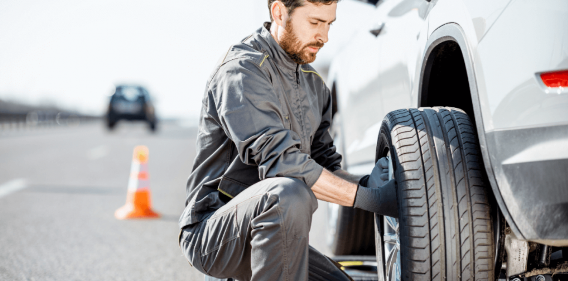 A technician that is putting on a tire during a Roadside Tire assistance and flat tire repair service.