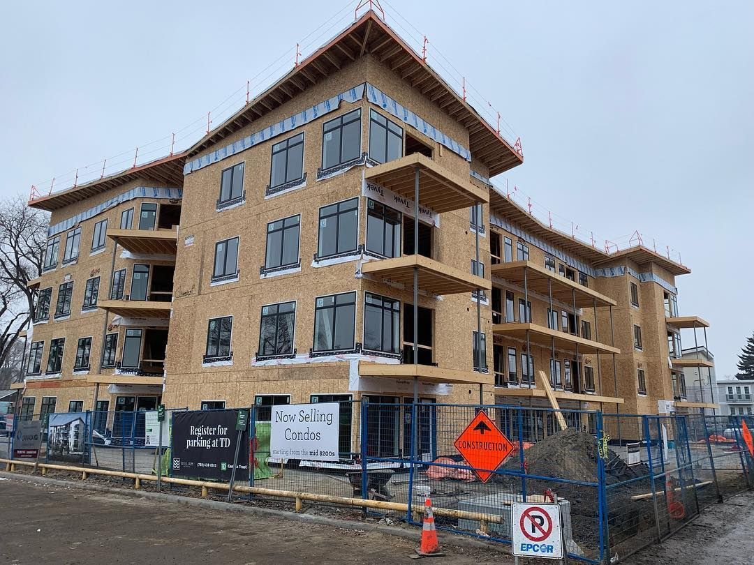 A large building under construction with a lot of windows and balconies.