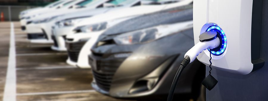 a row of electric cars in a parking lot