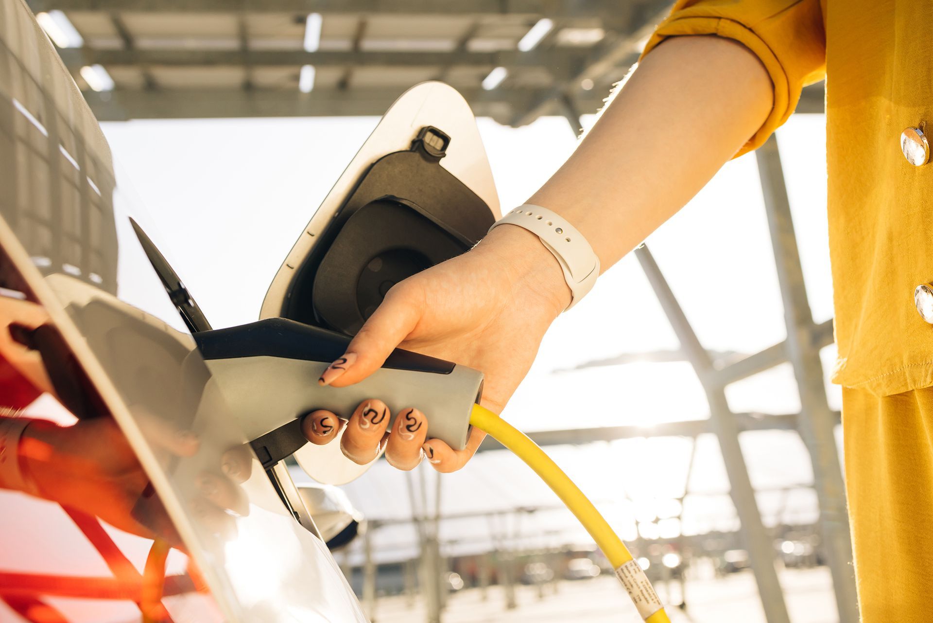 a person pumping gas into a car at a gas station
