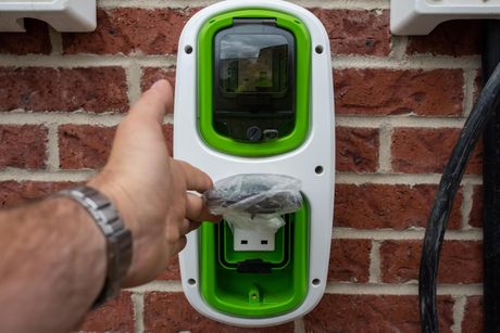 a man is holding a green and white device