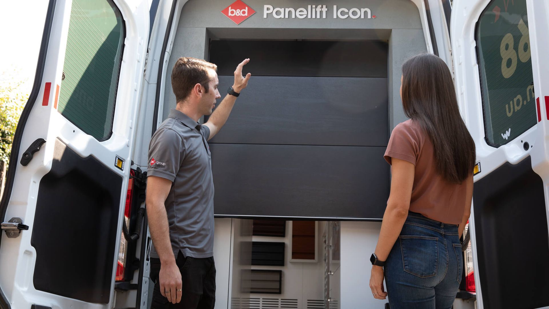 Two people stand by an open truck display, looking at a kiosk labeled “Panelift Icon.”