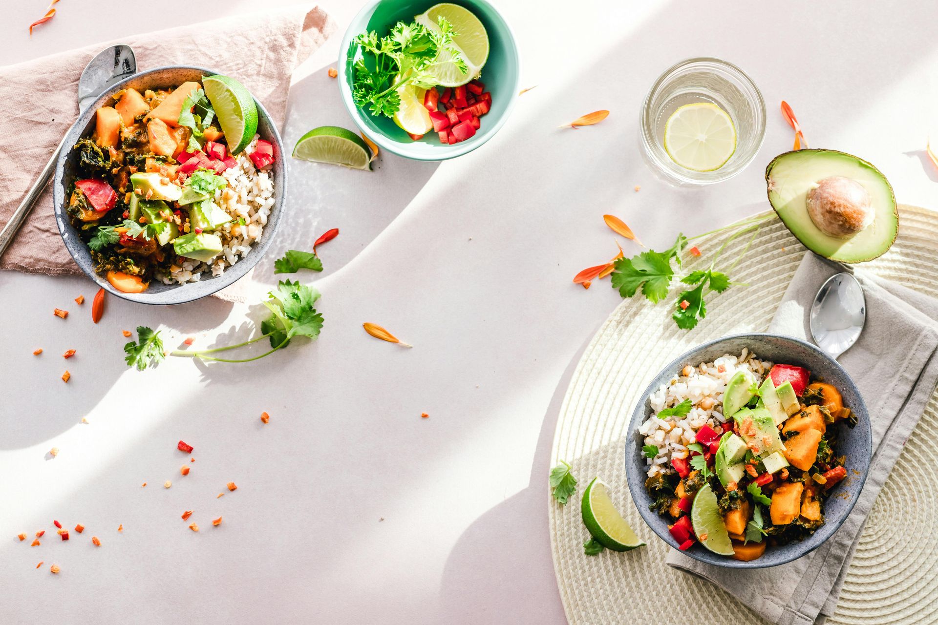 A table topped with bowls of food and a glass of water.