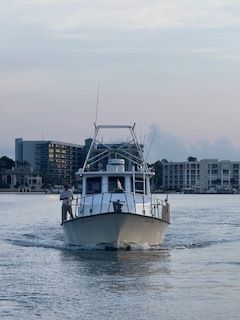 A boat is floating on top of a body of water.