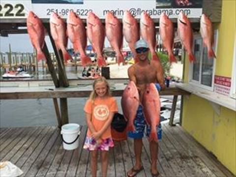 people standing with fishes