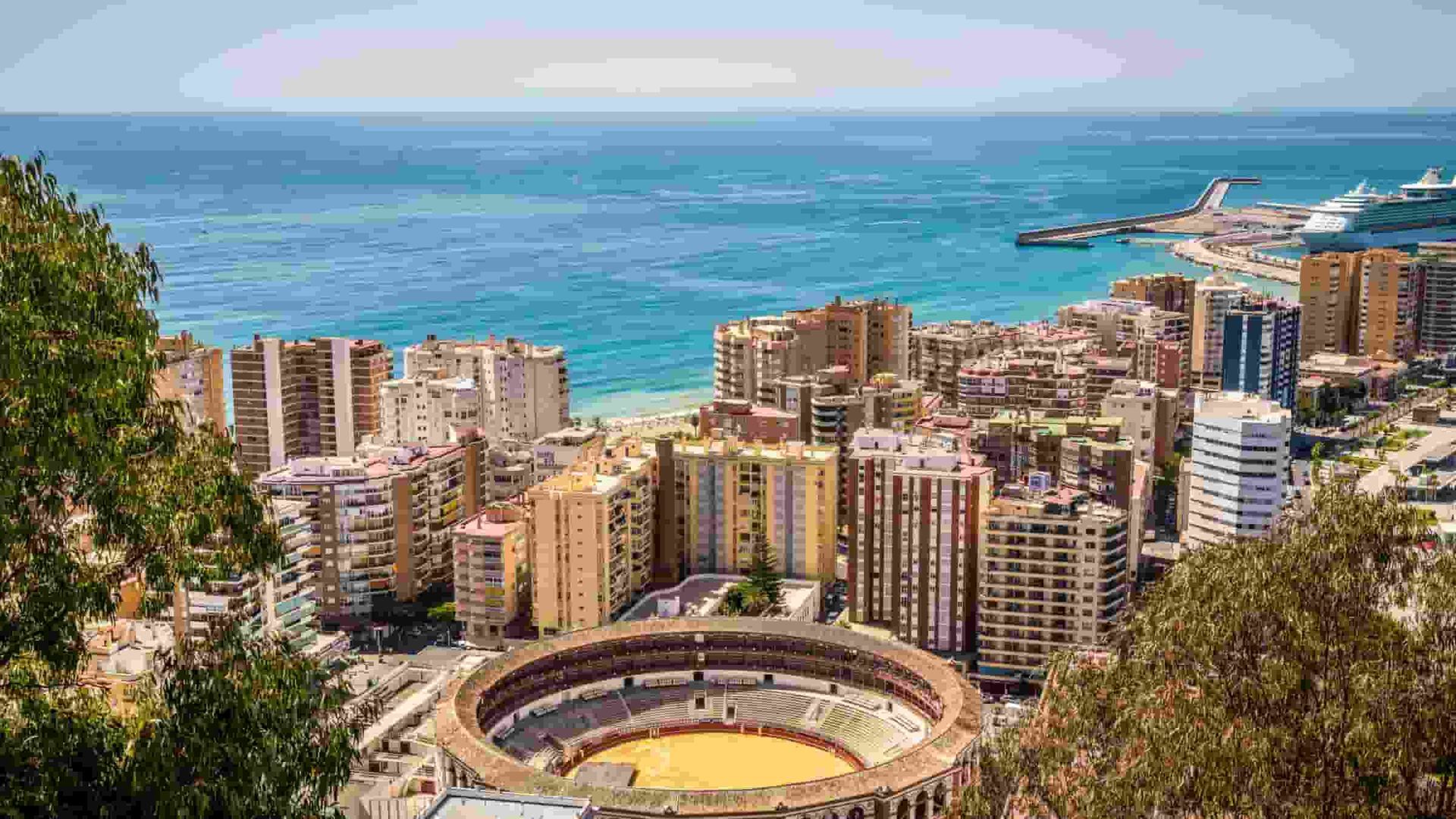An aerial view of Malaga with a bullring in the middle of it.