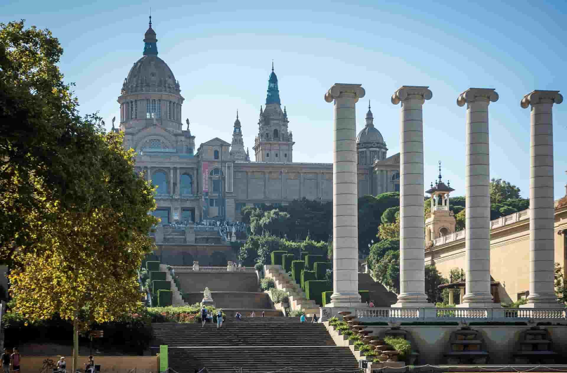 A row of columns in front of a large building in Barcelona.
