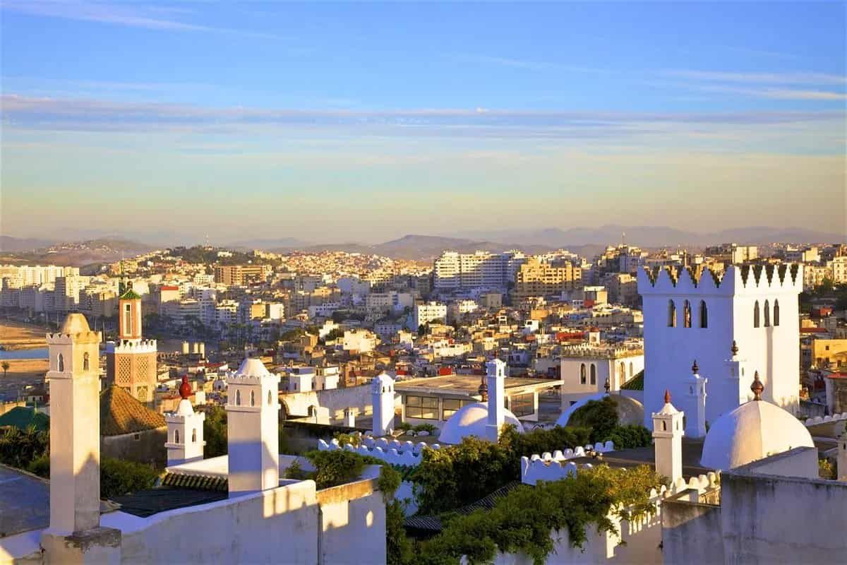 An aerial view of Tangier with a lot of white buildings and chimneys.
