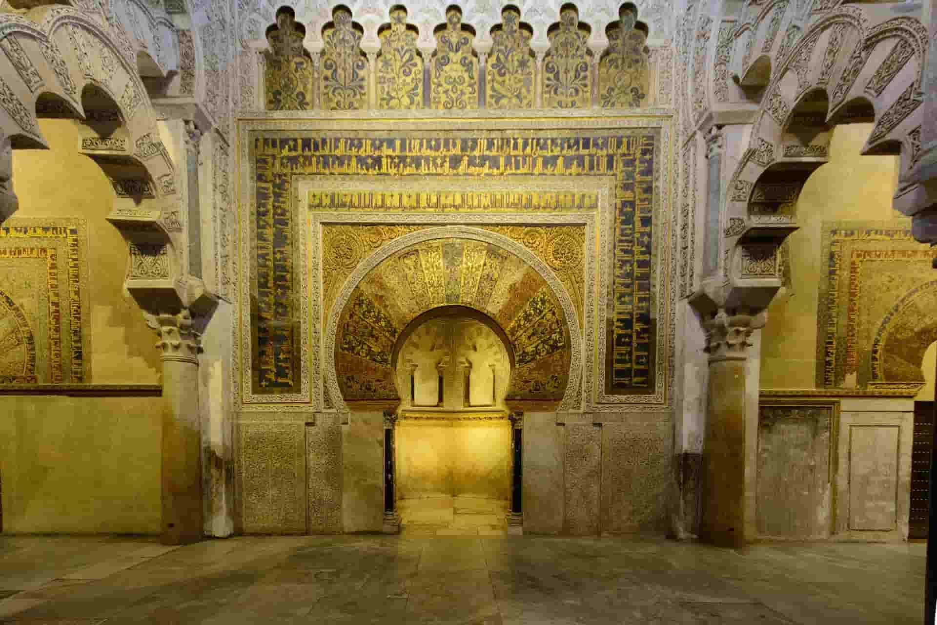 The inside of a building in Cordoba with arches and columns