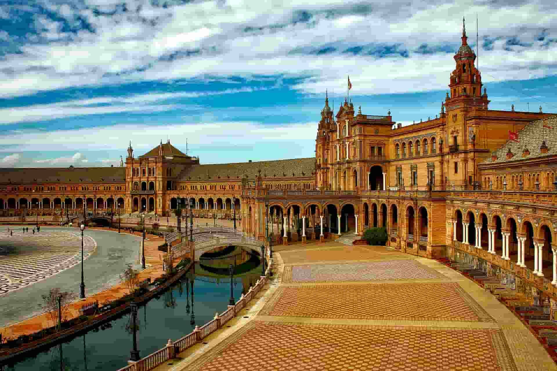 An aerial view of Seville with a large building in the background