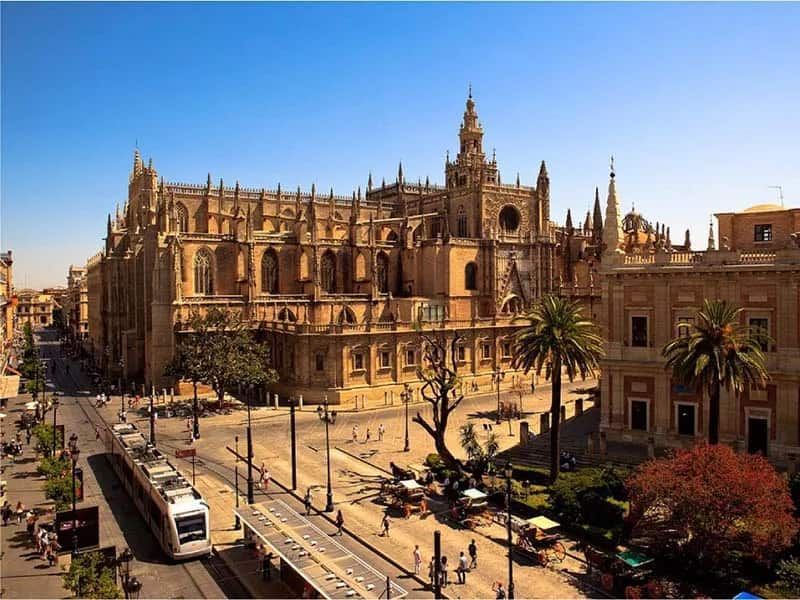 An aerial view of Seville with a large building in the background