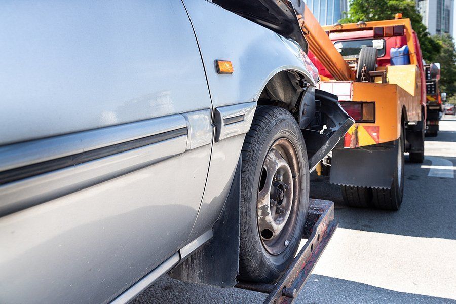 damaged car being towed