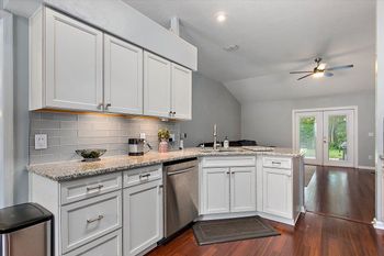 Modern kitchen with white cabinets and stainless steel appliances