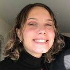 A close up of a woman 's face with a smile on her face.