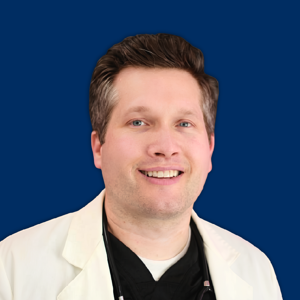 Person in a white lab coat smiling against a blue background