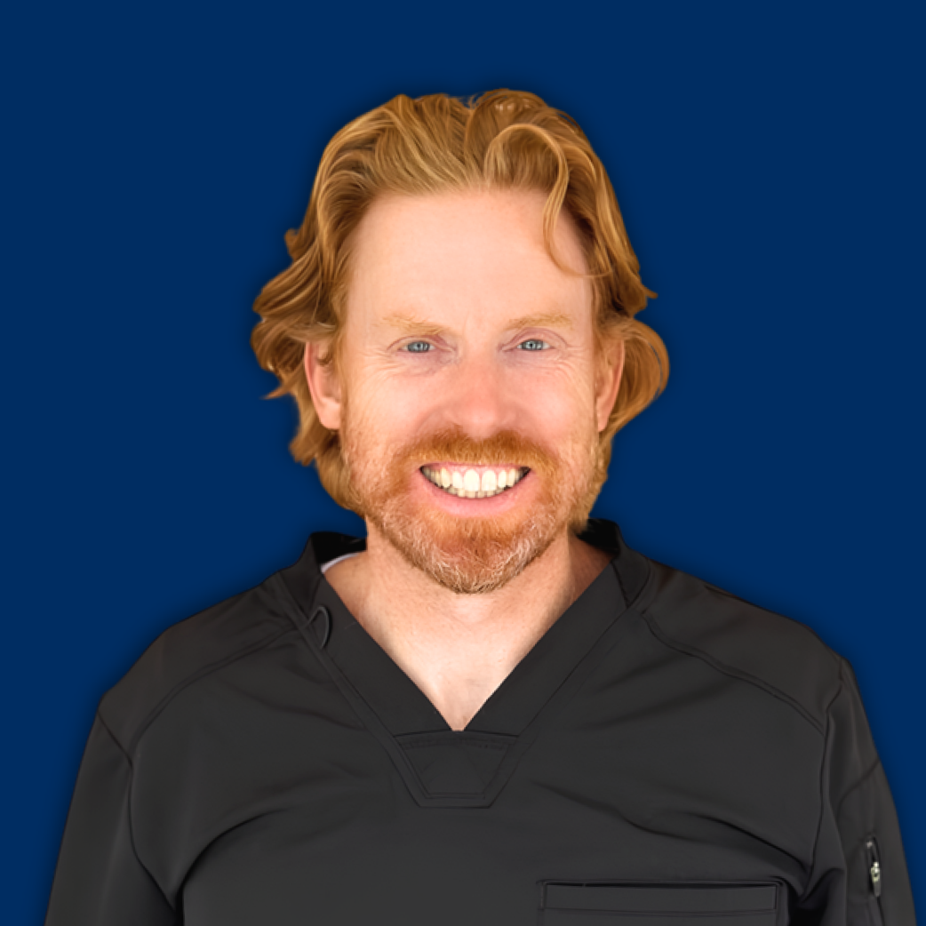 Smiling person in a black hoodie against a solid blue background