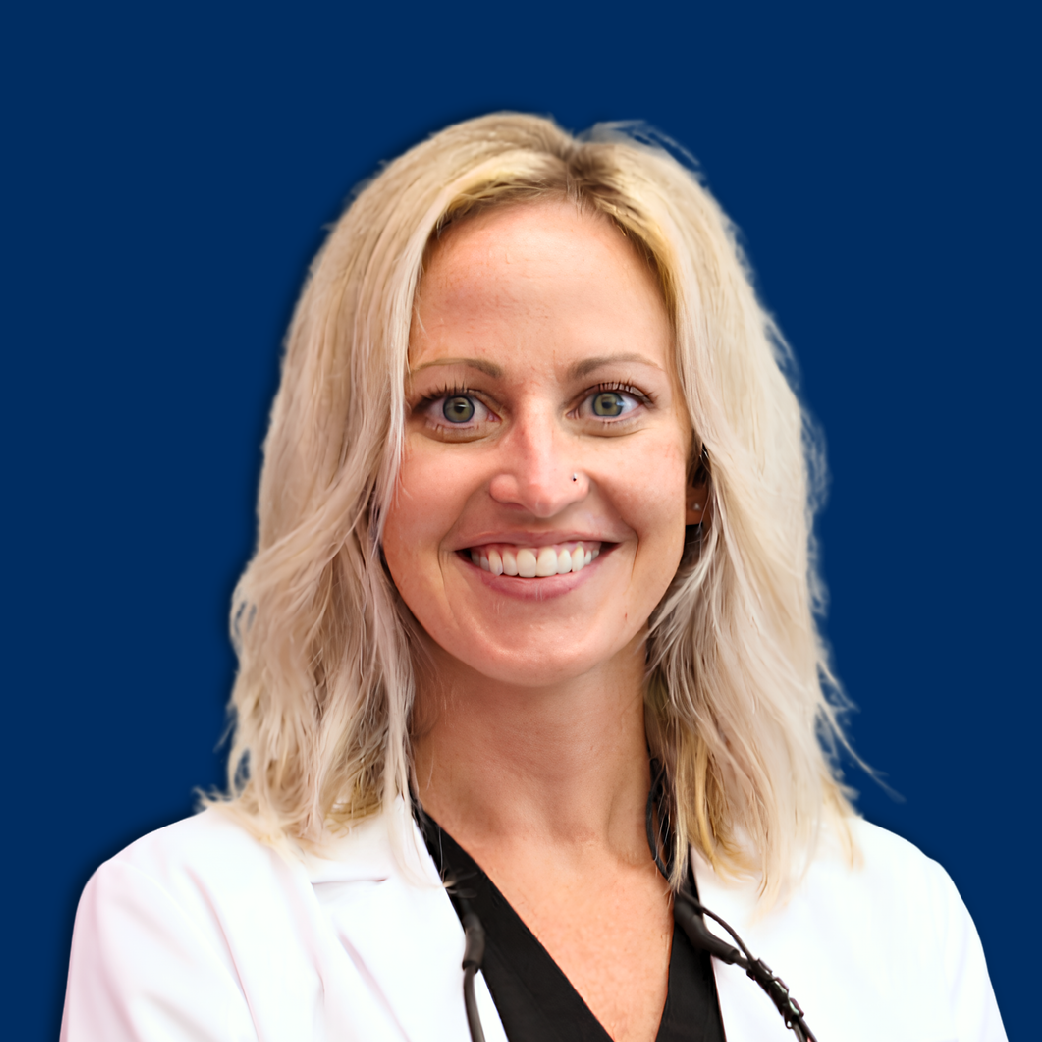 Smiling woman in a white blazer against a blue background