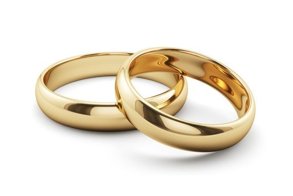 Two gold wedding rings, one in front of the other, on a white background.