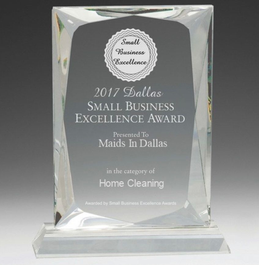 A glass 2017 Dallas Small Business Excellence Award plaque presented to Maids In Dallas for Home Cleaning.