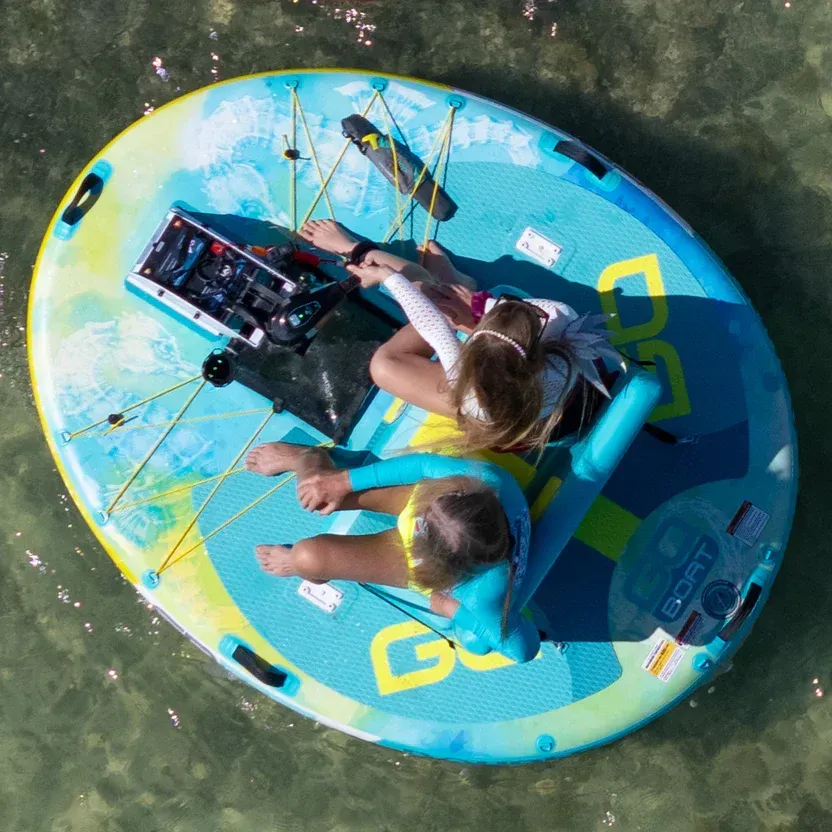 Two people are sitting on a raft that says go on it